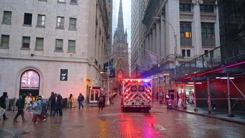 Numerous lights flash on the ambulance car heading to the narrow street. Façade Stock Footage 329191799