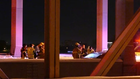 Numerous paramedics and firemen standing by after crash on bridge Stock Footage 85295178