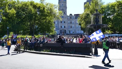 Numerous protesters getting ready for protest near fountain Stock Footage 95266979