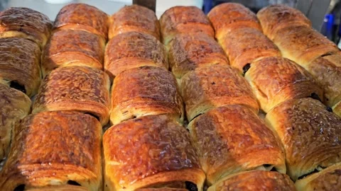 Numerous rows of golden brown baked chocolate puffs Stock Footage 311883732