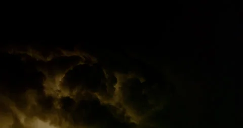 Numerous sheet-lightning strikes illuminate their parent storm clouds. 動画素材 320722669
