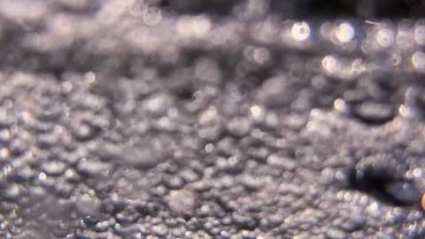 Numerous underwater air bubbles and tiny particles move through seawater in flow Stock Footage 346442842