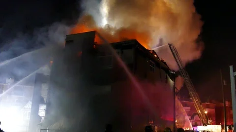 Numerous water jet at building fire Stock Footage 125453200