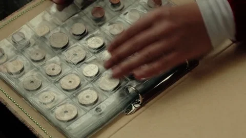 Numismatics concept. Collection of coins from different countries in album Video stock 83112277
