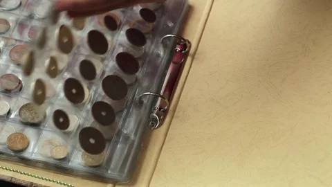 Numismatics concept. Collection of coins from different countries in album Video stock 83112604