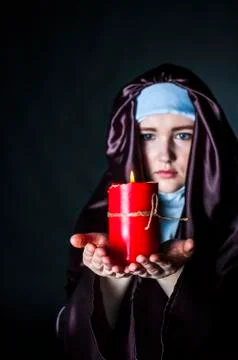 Nun with candle. Stock Photos