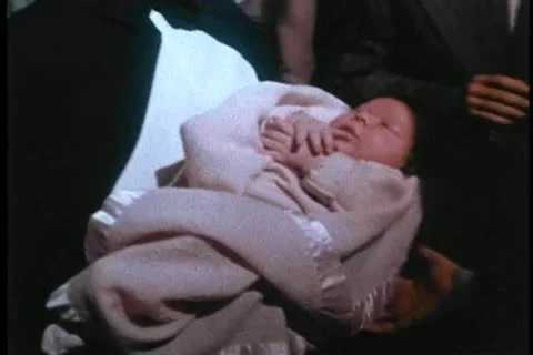 Nun passing an infant to man during ceremony Stock Footage 11365774