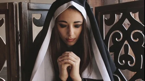 Nun pray and looks into camera Stock Footage 75601344