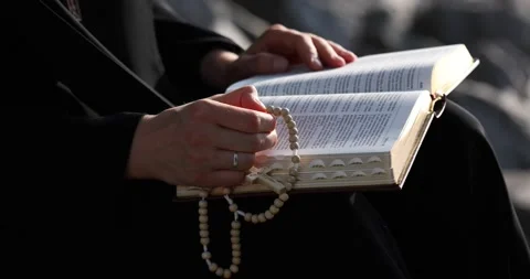 The nun sister is flipping through the Scriptures Stock Footage 140602554