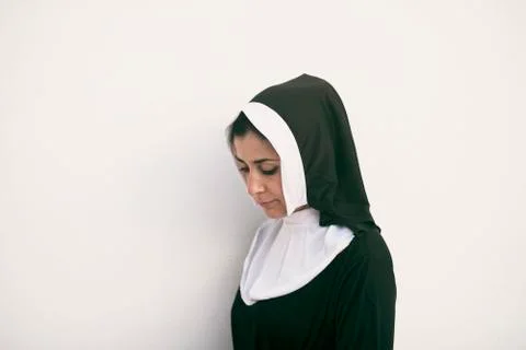 Nun on white background looking down Stock Photos