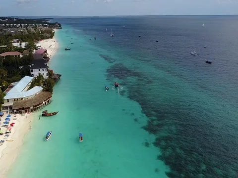 Nungwi beach Zanzibar with white sand turquoise sea and resorts. Stock Footage