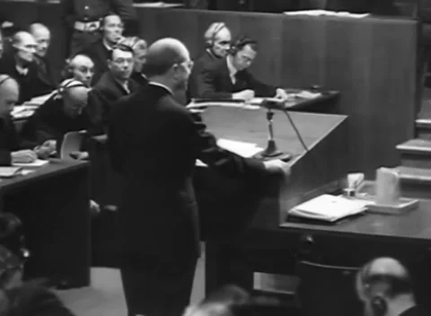 NUREMBERG - 1945: Hearing support - Speaker reads as court staff work Stock Footage 344489922