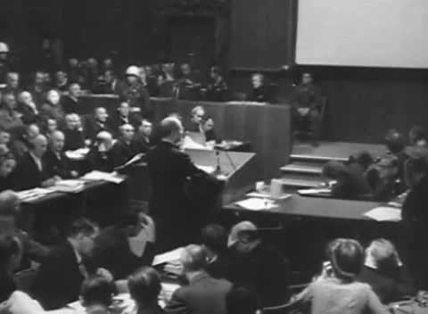 NUREMBERG - 1945: Press - Worker raises paper during address Stock Footage 344489815