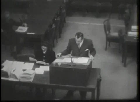 NUREMBERG - 1946: Counsel table stacked with open binders Видео 342921094