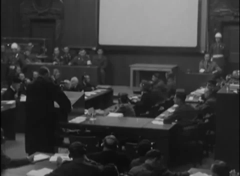 NUREMBERG - 1946: IMT proceedings — Screen dominates dark court wide 库存影片 343542249