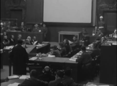 NUREMBERG - 1946: IMT proceedings — Two guards frame courtroom wide Stock Footage 343542259