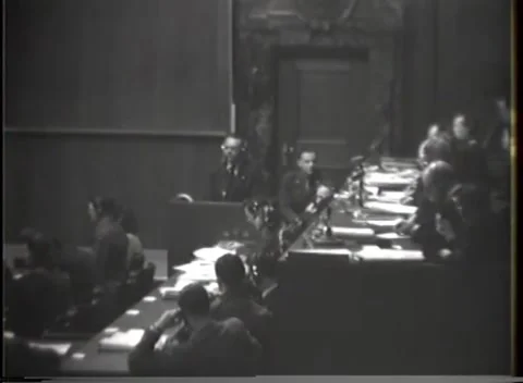 NUREMBERG - 1946: War crimes hearing — Long table recedes from witness box Stockbeeldmateriaal 343320828