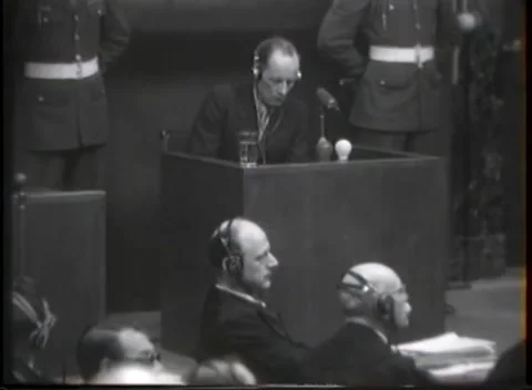 NUREMBERG - 1946: War crimes hearing — Witness rises between white helmets 库存影片 343320853