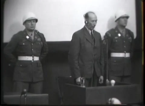 NUREMBERG - 1946: War crimes hearing — Raised hand at guarded stand Stock Footage 343320858