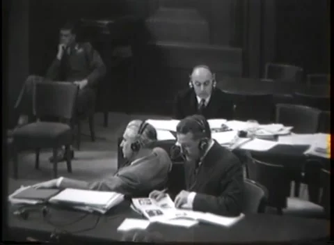 NUREMBERG - 1946: War crimes hearing — Counsel at end of long table 動画素材 343320868