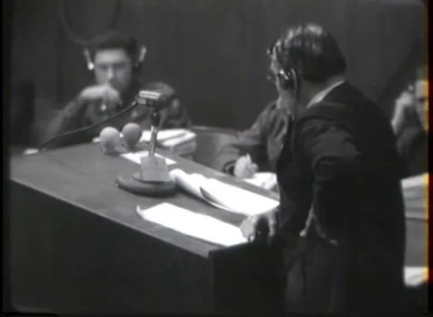 NUREMBERG - 1946: War crimes hearing — Covered typewriter among court staff Video stock 343320869