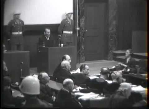 NUREMBERG - 1946: War crimes hearing — Crowded benches before carved door Stock-Footage 343320874