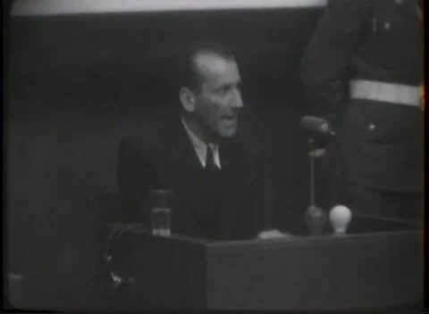 NUREMBERG - 1946: War crimes hearing — Hands rest on witness box panelling Видео 343320875