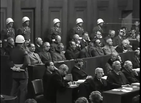 NUREMBERG - 1946: War Crimes Trials — Line of guards behind the dock Stock Footage 342818806