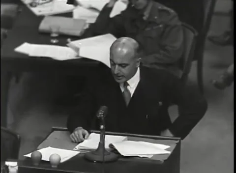 NUREMBERG - 1946: War Crimes Trials — Document sheet raised behind Stock Footage 342819301