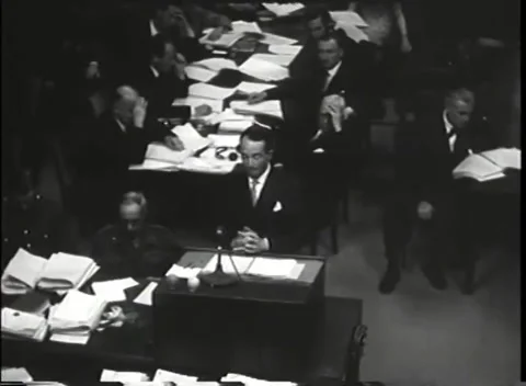NUREMBERG - 1946: War Crimes Trials — Speaker gestures over the microphone Stock Footage 342919339