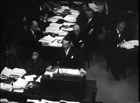 NUREMBERG - 1946: War Crimes Trials — Address with counsel working behind Видео 342919352