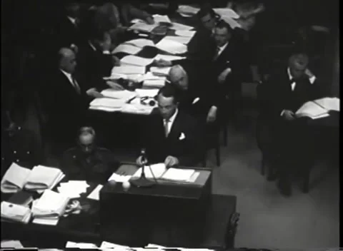 NUREMBERG - 1946: War Crimes Trials — Speaker at the desk, court seated Stock Footage 342919370
