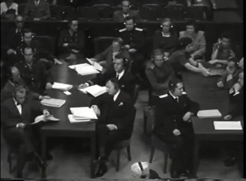 NUREMBERG - 1946: War Crimes Trials — Delegates in headphones, guard on post 库存影片 342919399