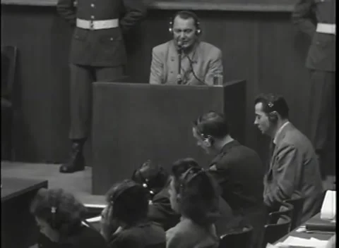 NUREMBERG - 1946: War Crimes Trials — Lit medium on Hermann Göring at the box Stock Footage 342919789