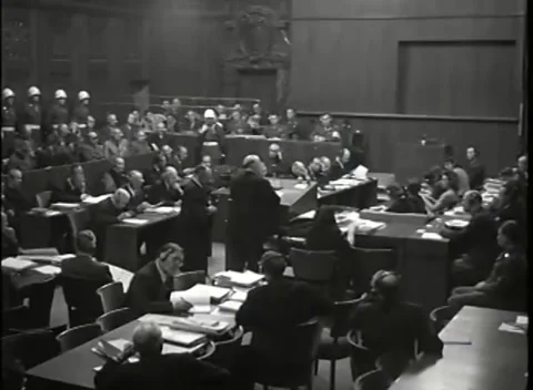 NUREMBERG - 1946: War Crimes Trials — Elevated wide from the tables to the dock Stock Footage 342919906