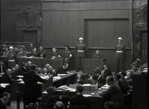 NUREMBERG - 1946: War Crimes Trials — Witness box between two helmeted guards Stock Footage 342919944