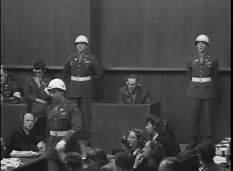 NUREMBERG - 1946: War Crimes Trials — Closer medium on the guards at the box Stock Footage 342919945