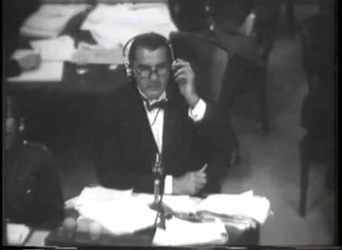NUREMBERG - 1946: War Crimes Trials — Counsel reads trial papers at the Видео 342919988