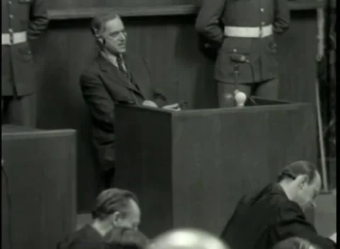 NUREMBERG - 1946: War Crimes Trials — A man in headphones at the witness box Stock Footage 342920114