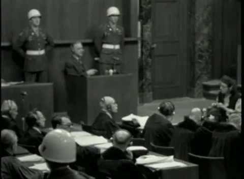 NUREMBERG - 1946: War Crimes Trials — The witness box between helmeted guards Stock Footage 342920167