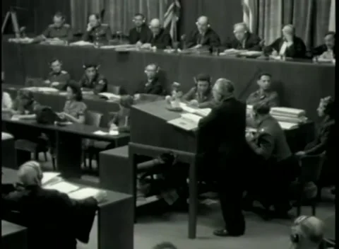 NUREMBERG - 1946: War Crimes Trials — From behind counsel toward the bench Stock Footage 342920170