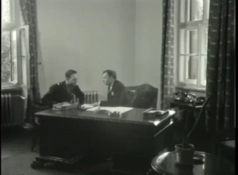 NUREMBERG - 1946: War Crimes Trials — Army officer stands beside the desk Stock Footage 342920299