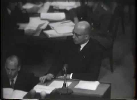 NUREMBERG - 1946: War Crimes Trials — Reading from typed pages at the microphone Stock Footage 342921179