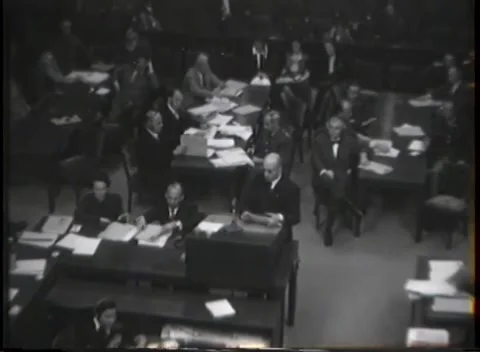 NUREMBERG - 1946: War Crimes Trials — Aide crosses behind the counsel tables Stock Footage 342921204