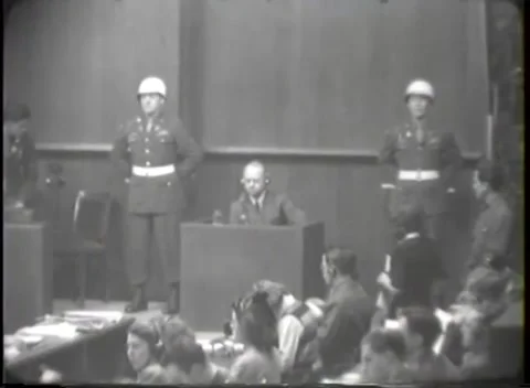 NUREMBERG - 1946: Witness box seen past seated court staff Stockbeeldmateriaal 342920853
