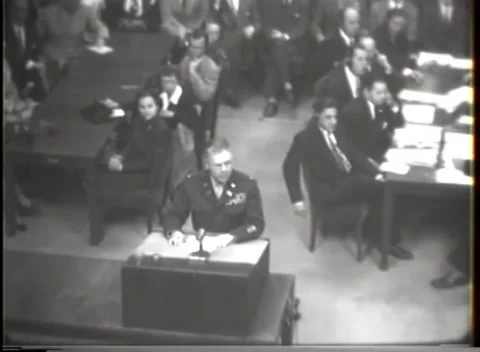 NUREMBERG - 1947: I.G. Farben case — Lectern view cuts to headset dock Stockbeeldmateriaal 343320914