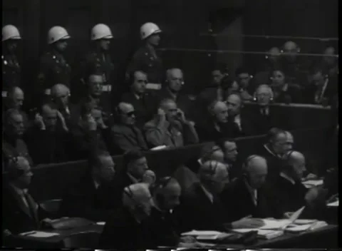 NUREMBERG, GERMANY - 1945: Earpiece - Man touches interpretation headset Stock Footage 344489643
