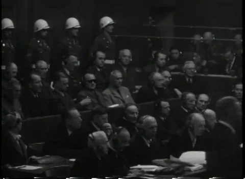 NUREMBERG, GERMANY - 1945: Layers - Guards stand over counsel and dock Stock Footage 344489639
