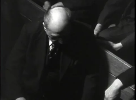 NUREMBERG, GERMANY - 1945: Patterned tie - Bald man bows behind the ledge Stock Footage 344902253