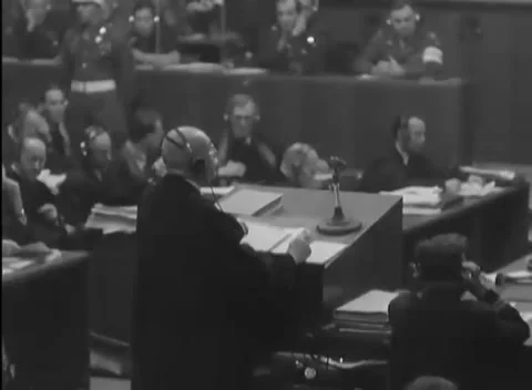 NUREMBERG, GERMANY - 1946: Address - Headset speaker faces raised officers Vídeo Stock 344490940